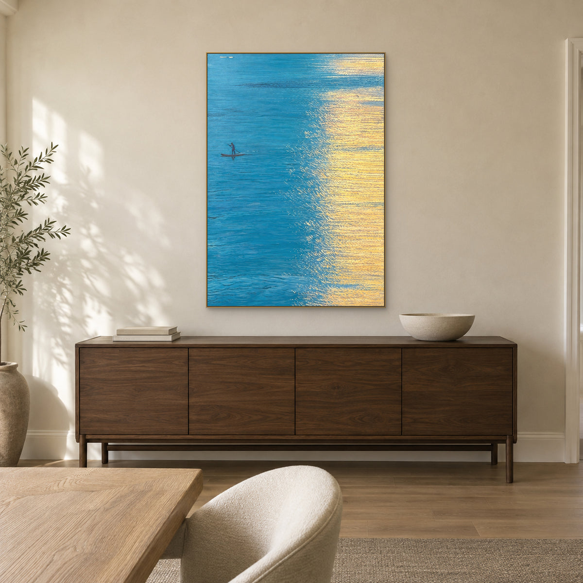 Golden Water painting in a champagne-tone frame above a dark walnut dining-room sideboard