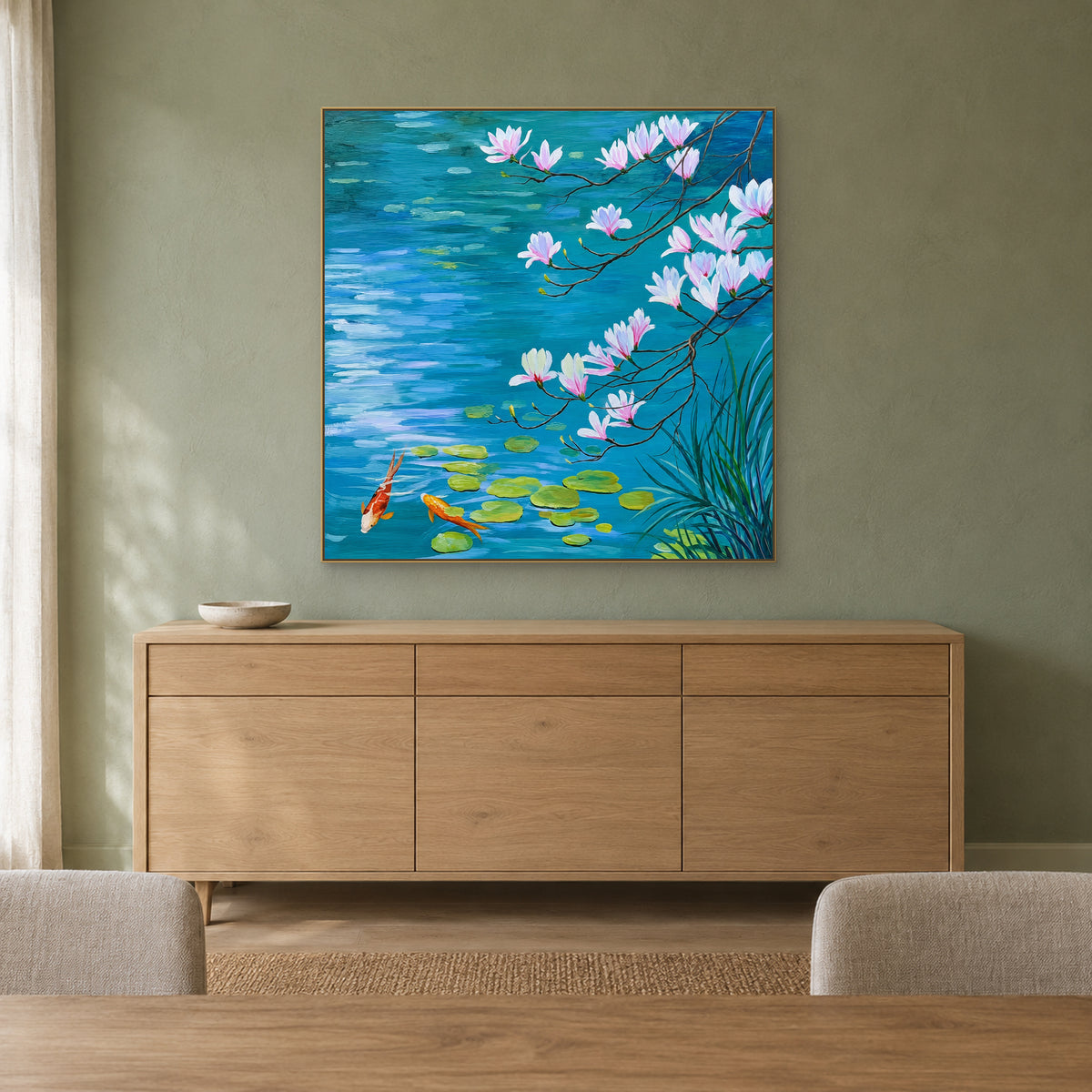 Square turquoise pond painting with a champagne-tone frame above an oak sideboard against a muted green wall