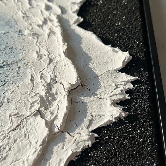 Close view of Silence in Onyx white surf and black textured shore