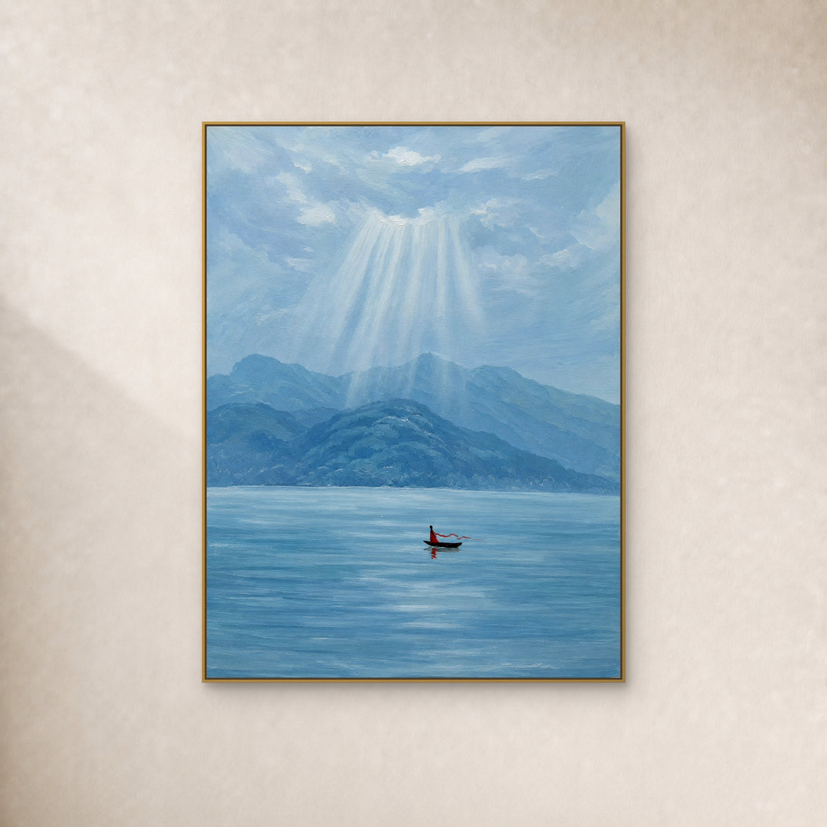 Vertical blue lake painting with pale sunrays and a small red figure in a boat, shown in a thin gold-toned frame on an ivory wall