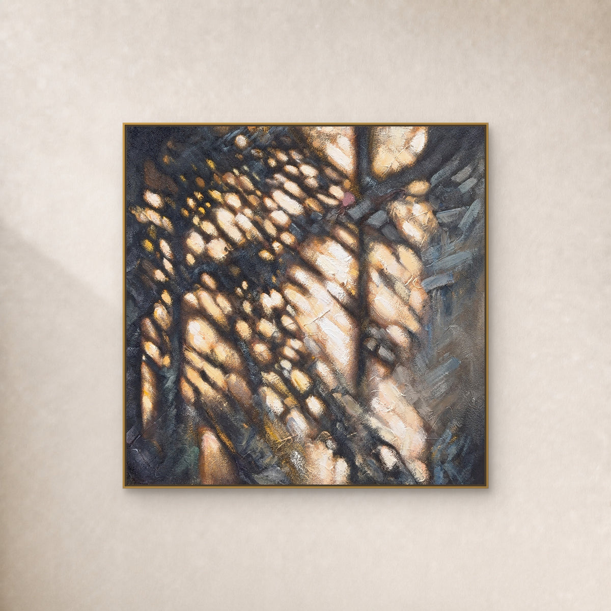 Square ochre and charcoal abstract painting in a thin gold floating frame on a warm ivory wall