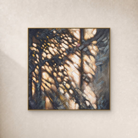 Square ochre and charcoal abstract painting in a thin gold floating frame on a warm ivory wall