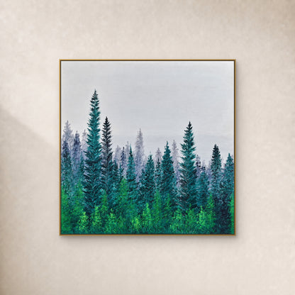 Square teal pine forest and pale grey mist in a slim gold-tone frame on an ivory wall