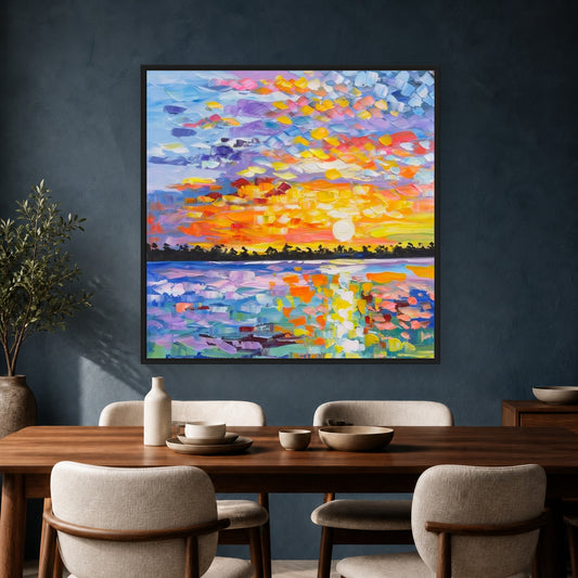 Colorful square sunset painting in a slim black floating frame above a dark wood dining table