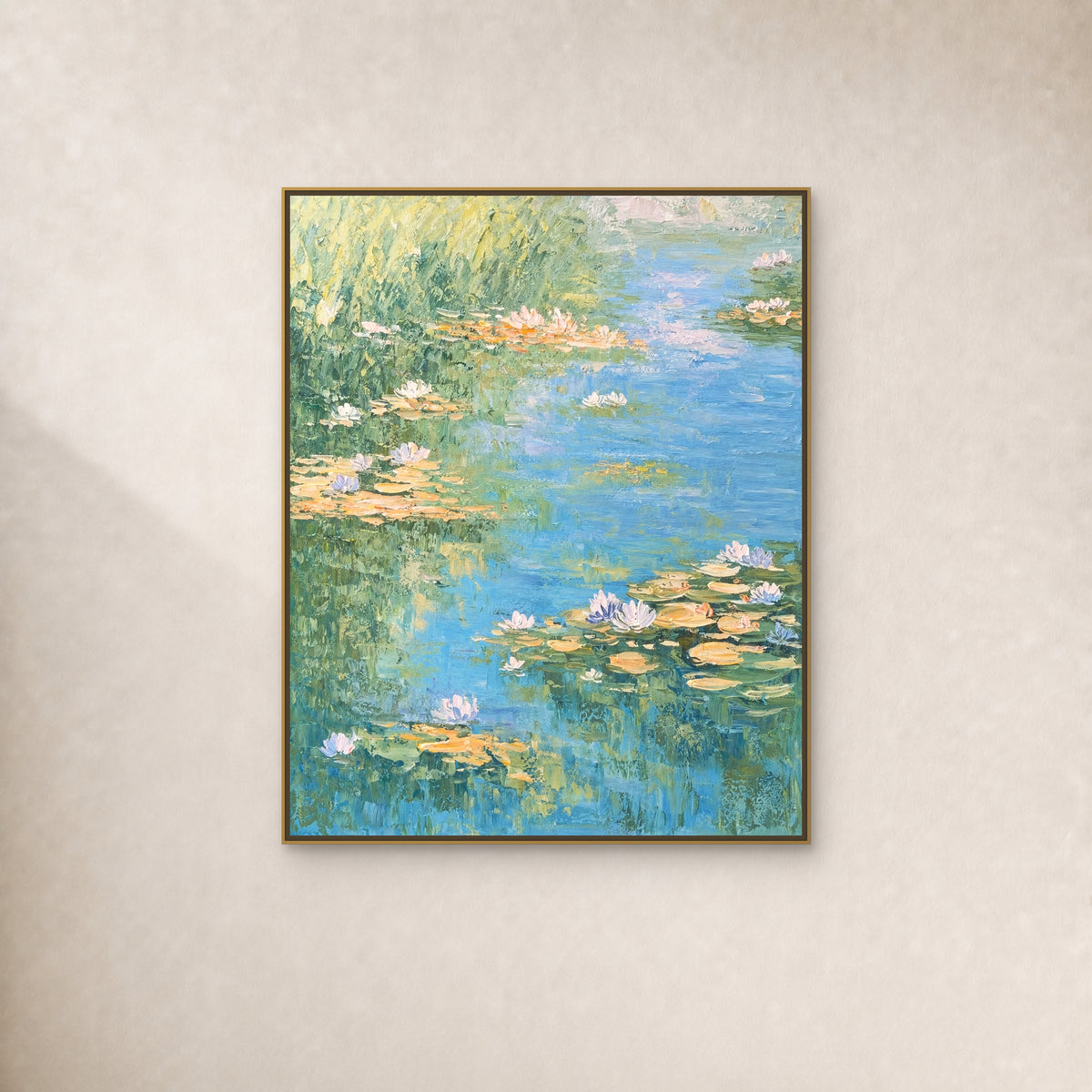 Water Lilies in Soft Light in a slim gold floating frame on a warm ivory wall