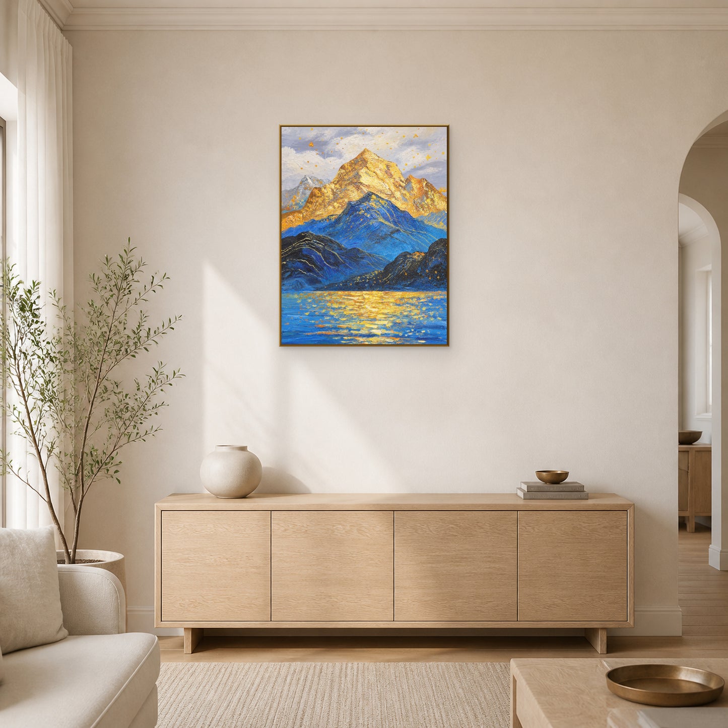 Golden Summit in a slim brass floating frame above a pale oak living room sideboard
