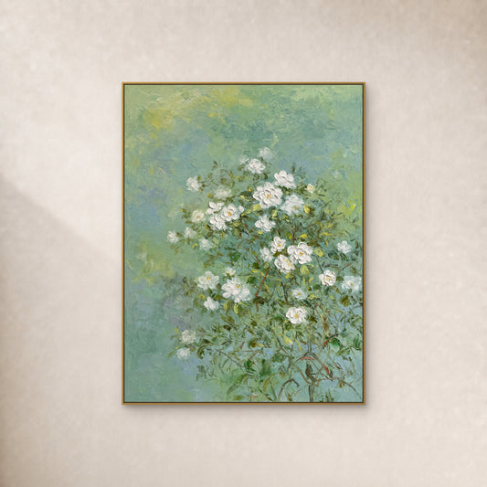 White jasmine painting on a soft green field in a slim gold floating frame against an ivory wall