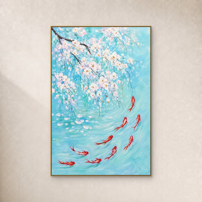 Nine red-and-white koi beneath white blossoms in turquoise water, in a slim gold-coloured floating frame on an ivory wall.