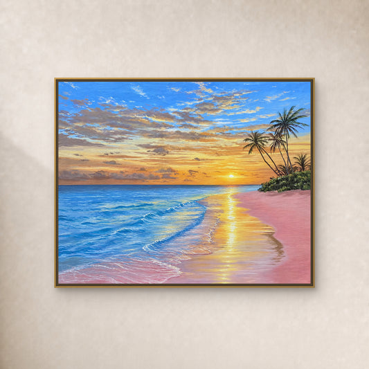 Pink beach and blue sea at sunset beneath slender palms, in a thin gold-toned floating frame on an ivory wall