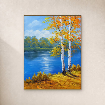 Two white birches beside a blue river and golden bank, in a slim gold-coloured frame on an ivory wall