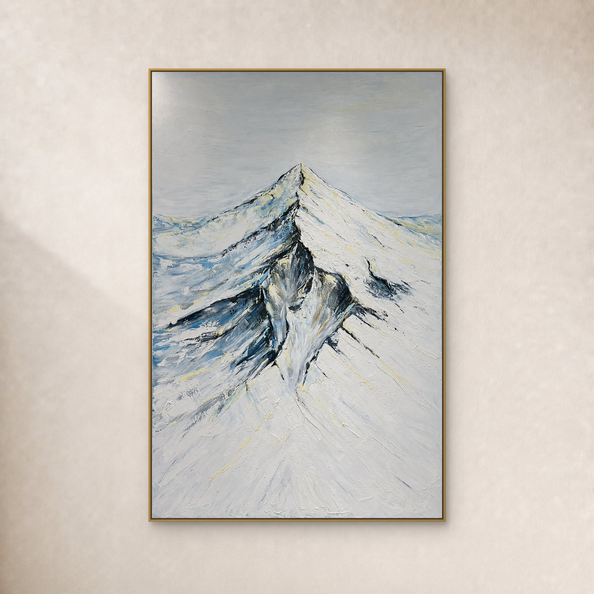 Snowcrest snowy mountain painting with ivory slopes and blue-grey shadows in a slim gold-tone frame on an ivory wall