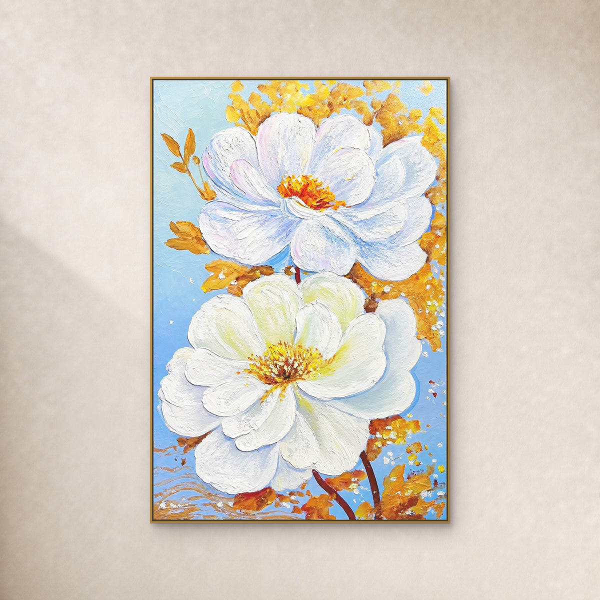 Two white blossoms with gold-coloured leaves on pale blue, shown in a slim gold-coloured floating frame on an ivory wall.