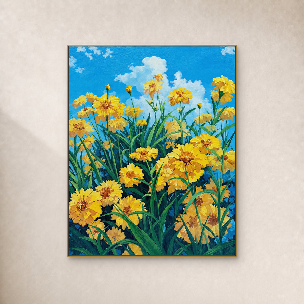 Yellow meadow flowers and green leaves beneath a blue sky, shown in a thin gold frame on an ivory wall