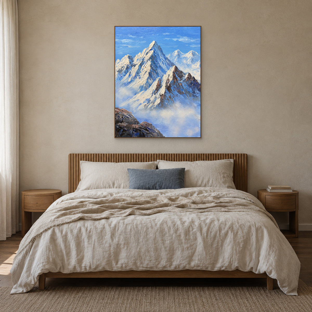 Blue snow mountain art in an oak-tone frame centred above a linen bed