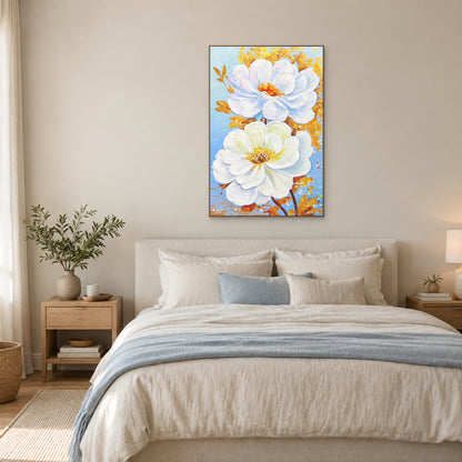 White Blossoms in Gold in an oak-coloured floating frame above a cream upholstered bed with pale blue bedding.