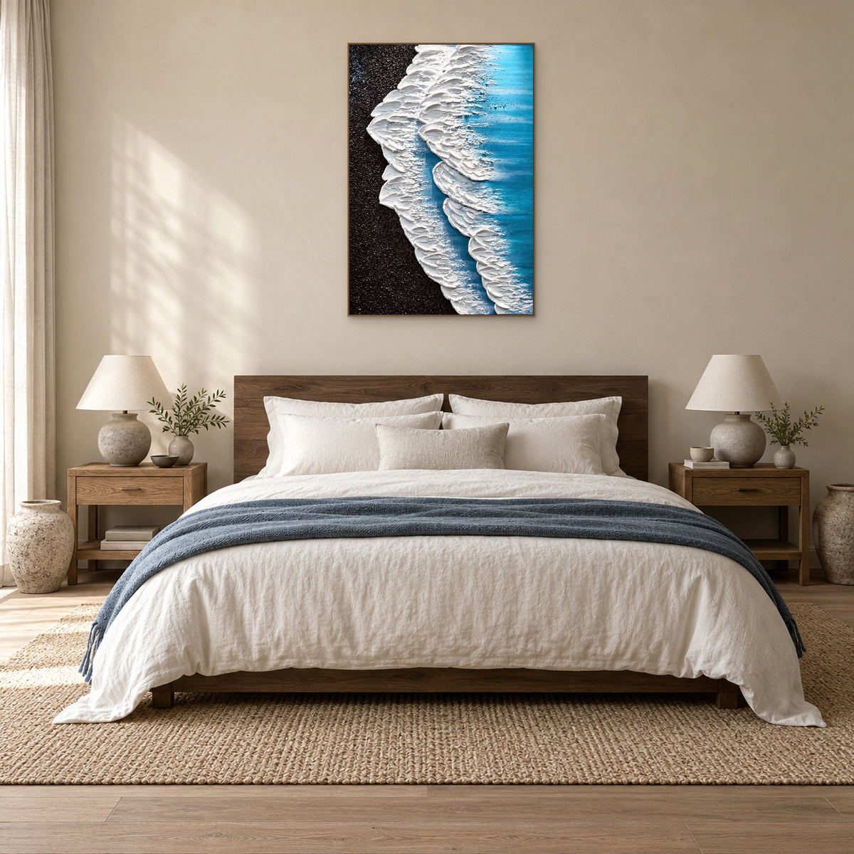 White surf painting in an oak-tone frame centred above a wooden headboard and cream bedding