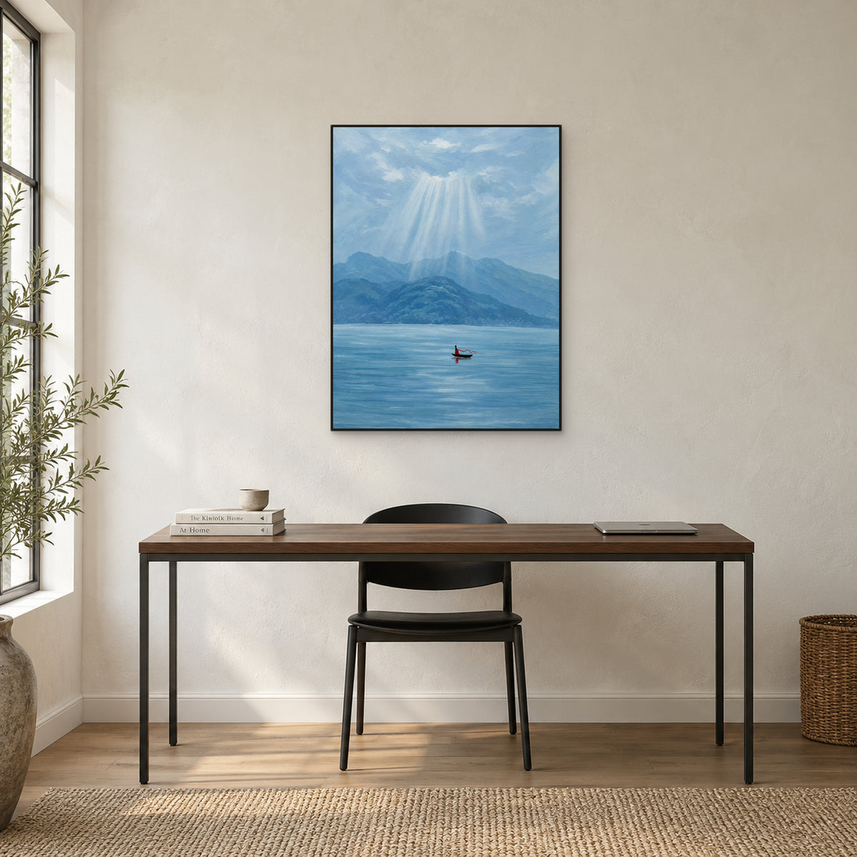 Sunray lake landscape in a slim black frame above a dark wooden desk beside a tall window