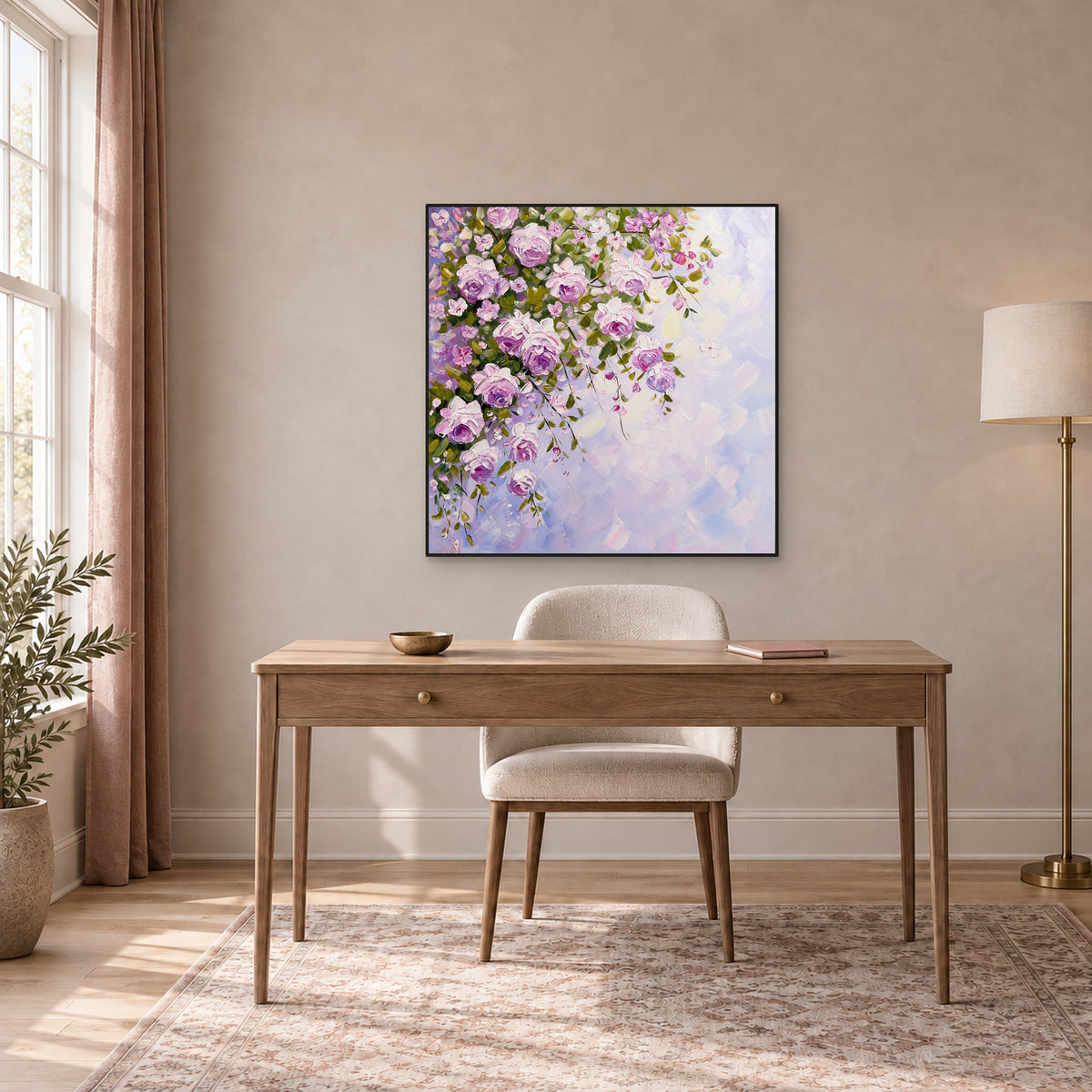 Square rose painting in a thin black frame centred above a wooden desk