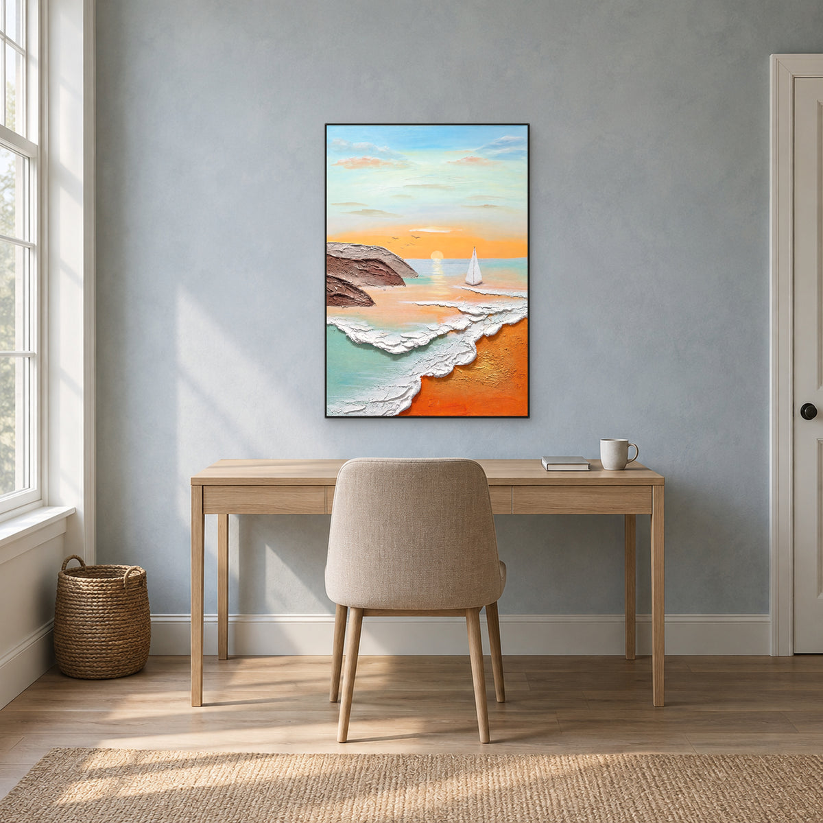 White sail and textured surf in a black floating frame above a light wood desk on a blue-grey wall