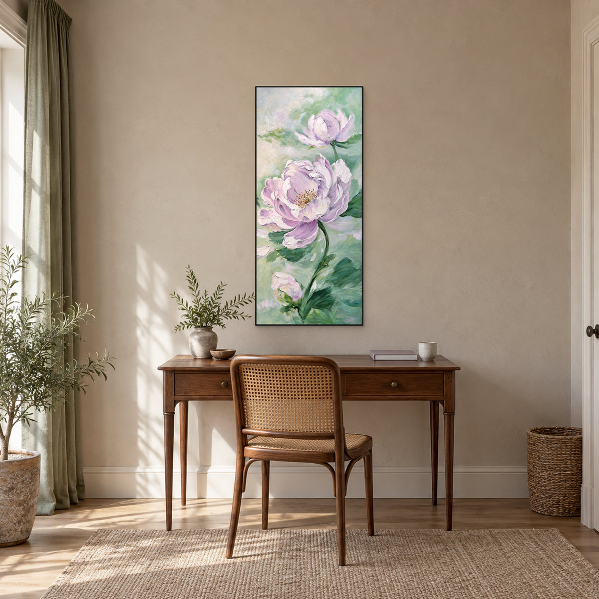 Narrow lilac and mint floral painting in a black floating frame above a wooden desk in a softly lit study