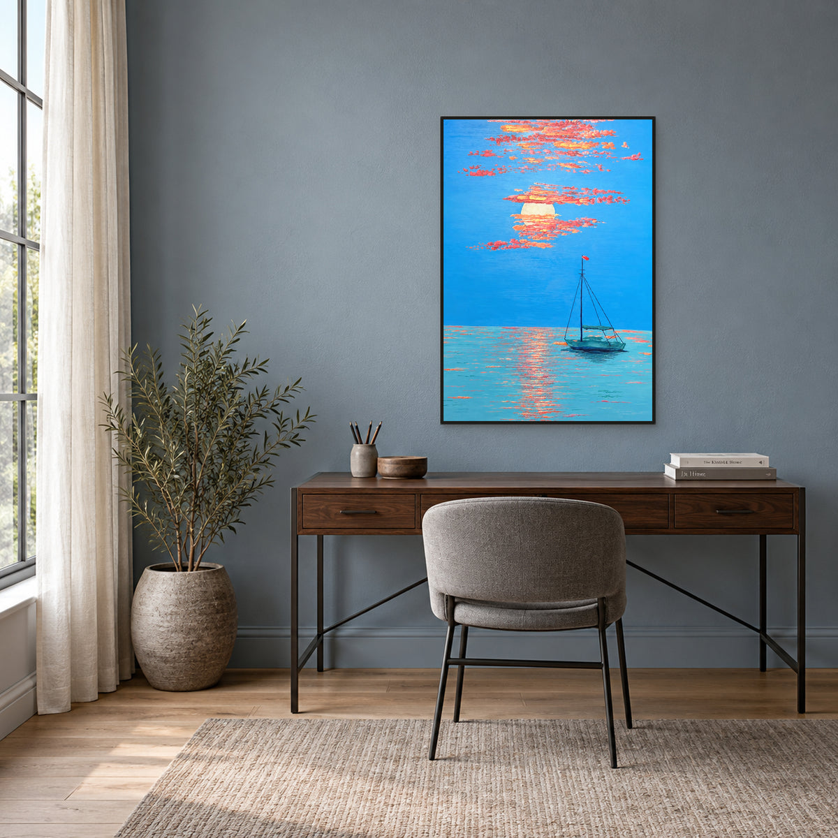 Tableau d’une barque bleu-vert sous un couchant corail, fin cadre flottant noir, au-dessus d’un bureau en noyer sur mur bleu-gris.