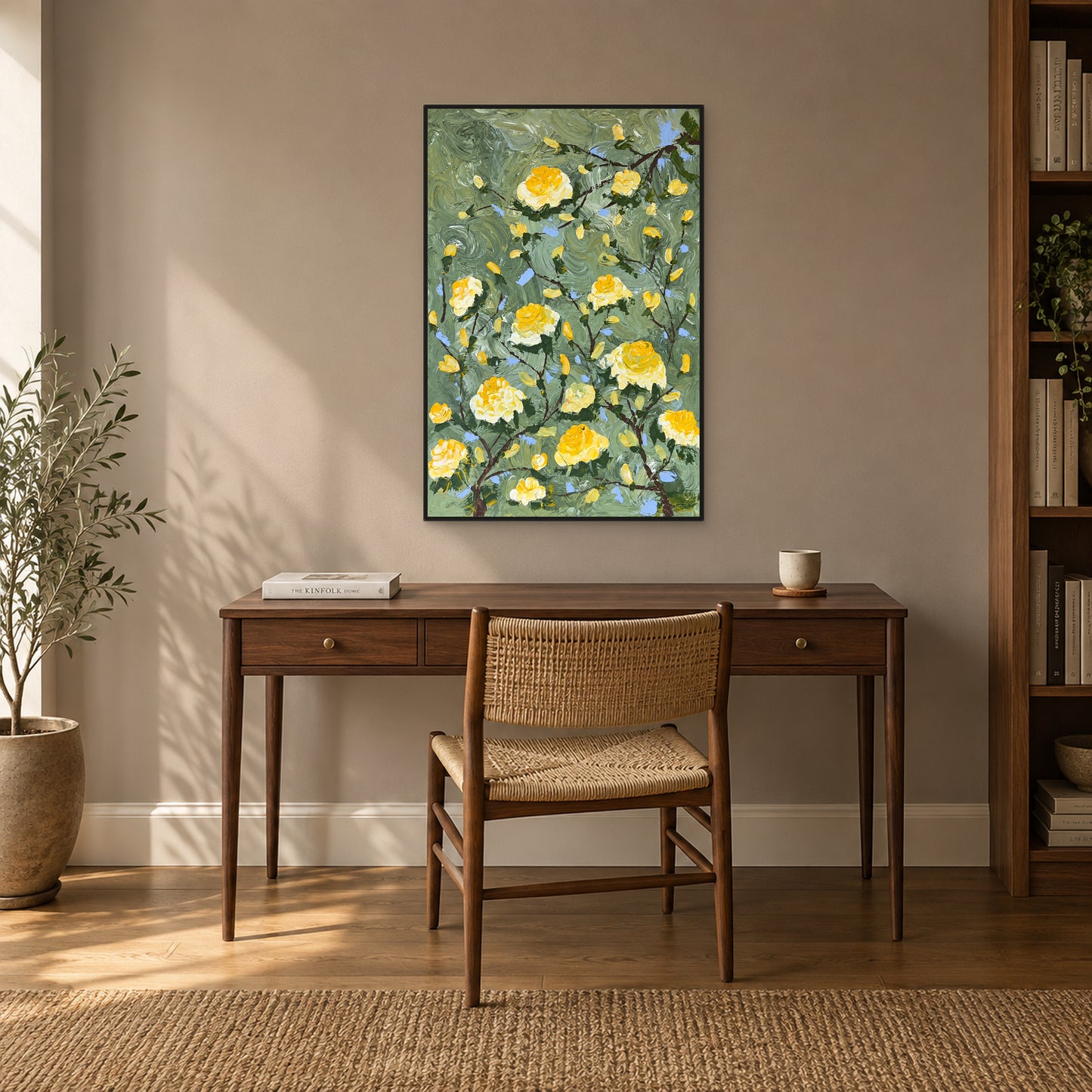Sage-green and yellow floral painting in a black floating frame above a walnut writing desk