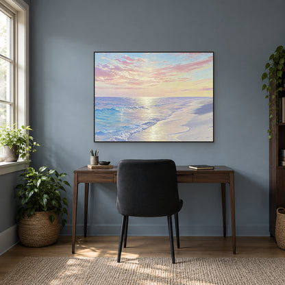 Horizontal pink-cloud beach painting in a black frame above a desk against a blue-grey wall
