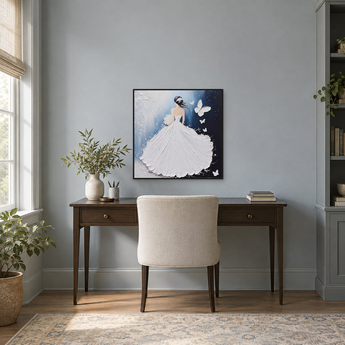 Blue and white figurative painting in a thin black frame above a wooden desk on a grey-blue office wall