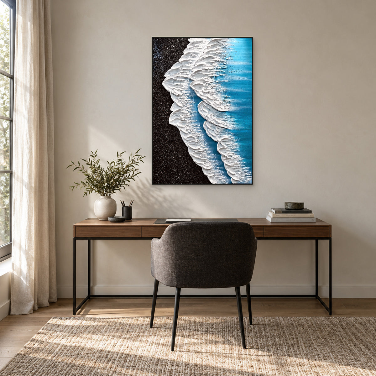 Black shore and blue water painting in a black frame above a dark wooden desk