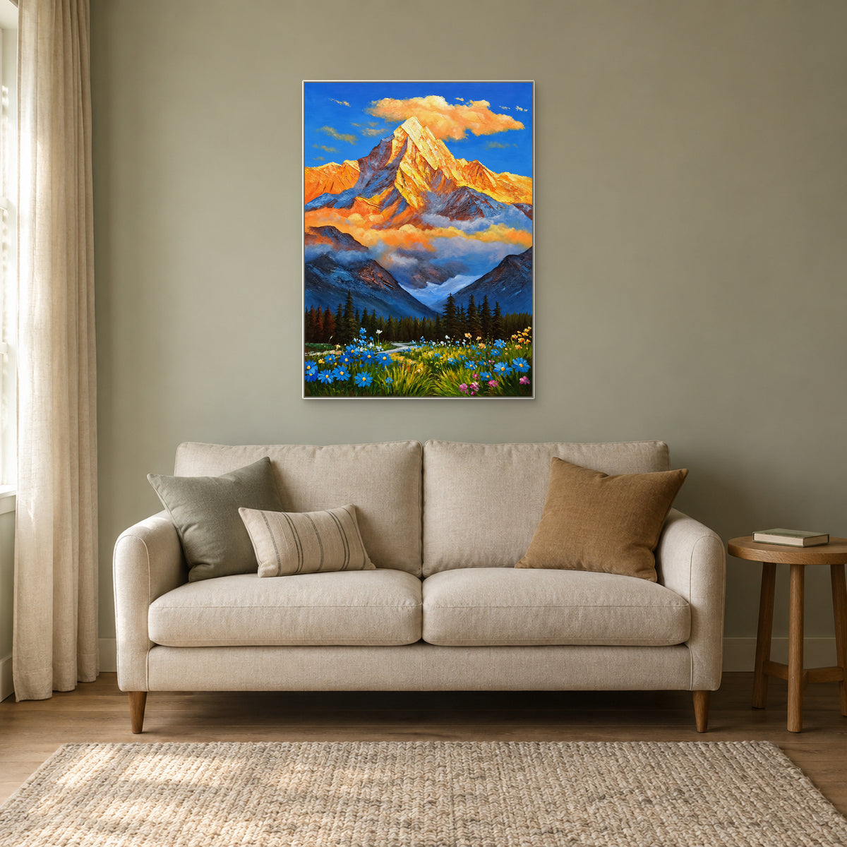 Vertical mountain and flower painting in a white floating frame above an oatmeal sofa on a pale sage wall