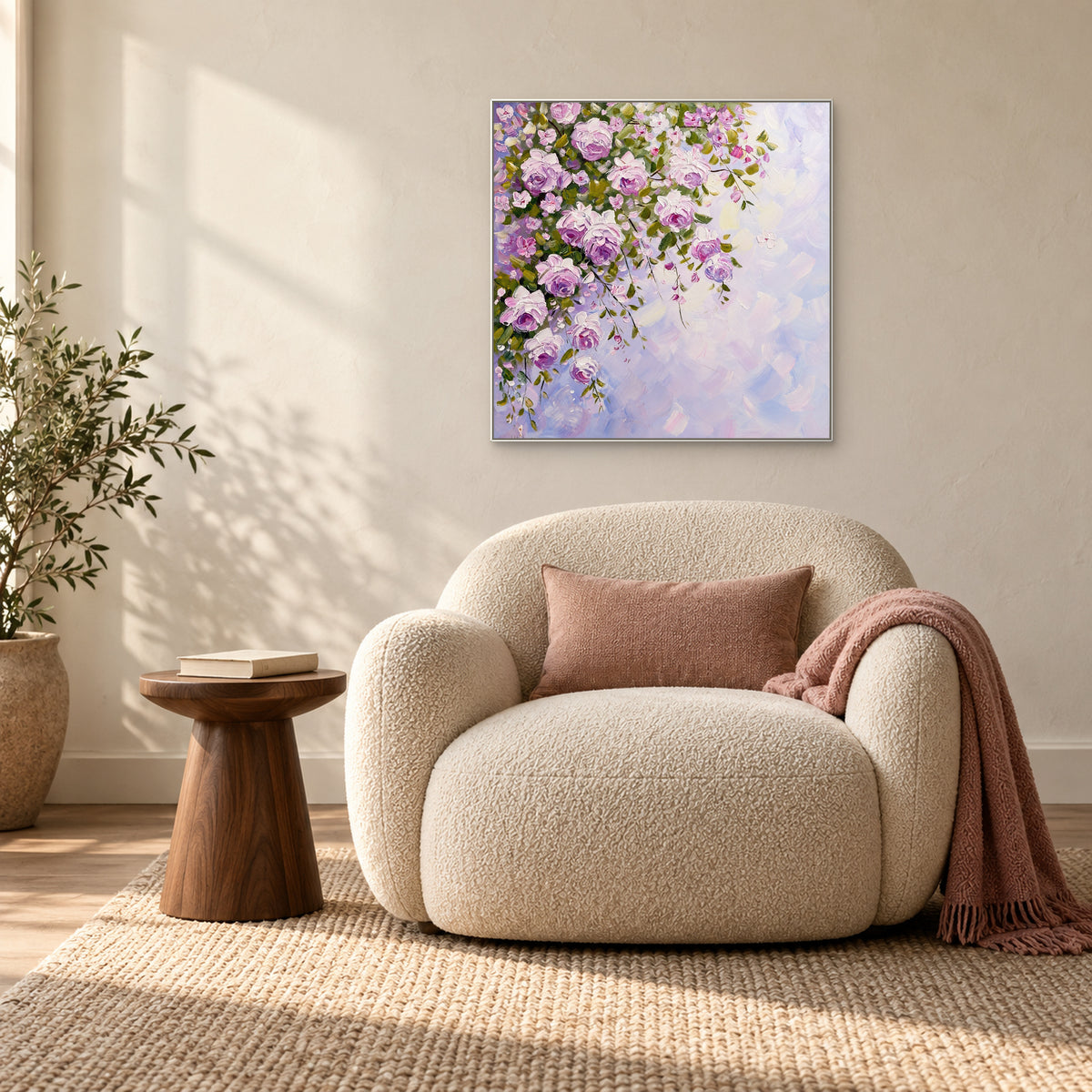 White-framed cascading rose painting above a cream armchair beside a window