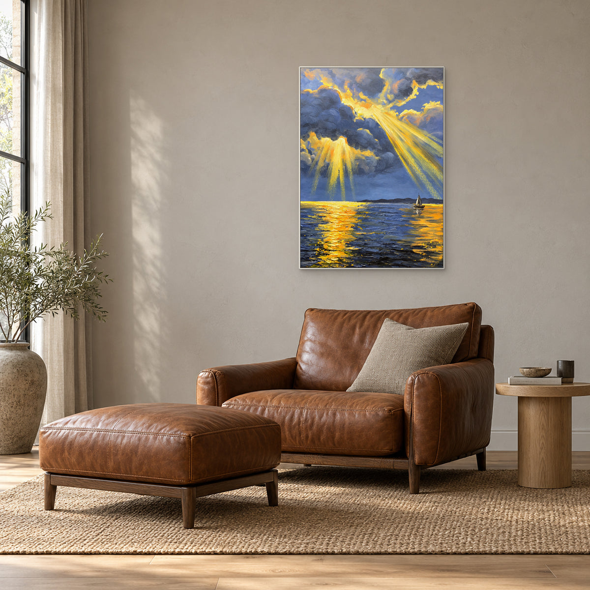 Vertical sunbeam painting in a white frame above a brown leather reading chair beside a tall window.