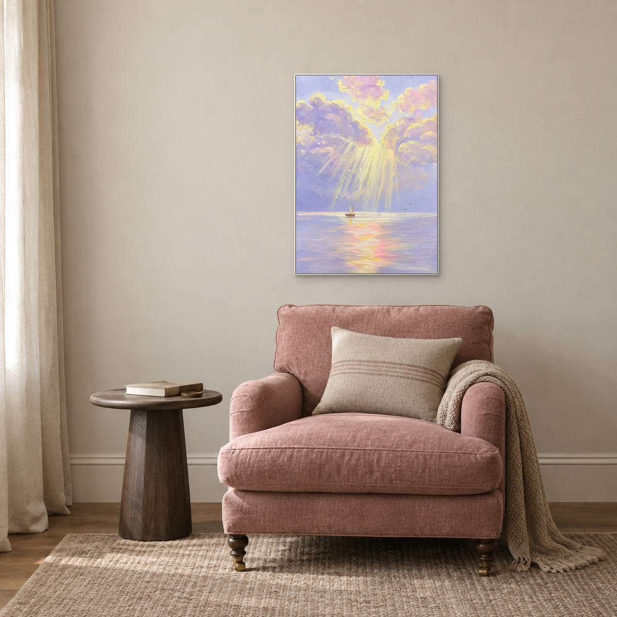 Vertical lilac seascape in a white frame above a dusty-pink reading chair beside a round side table.