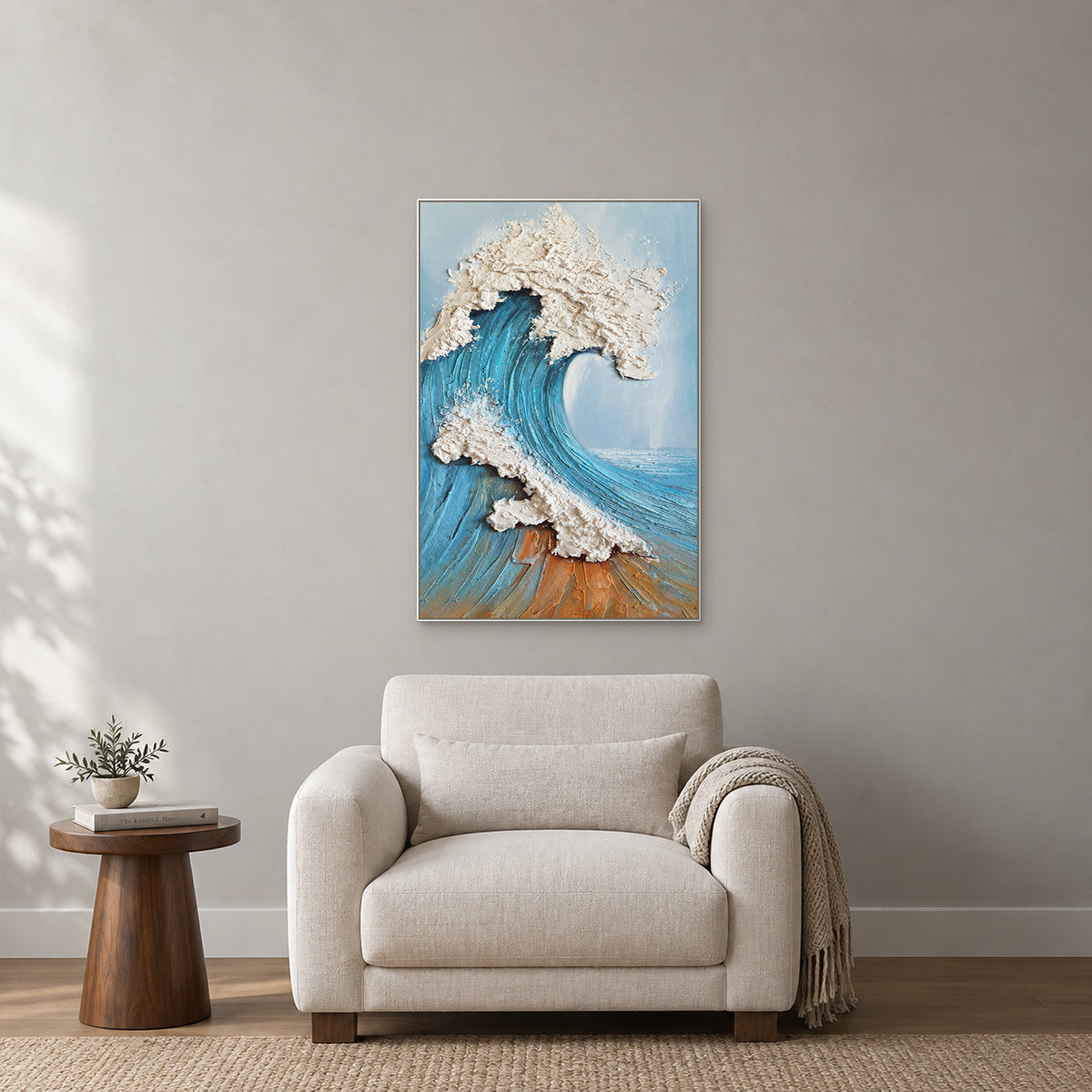 Textured ocean wave in a white floating frame above an ivory reading chair