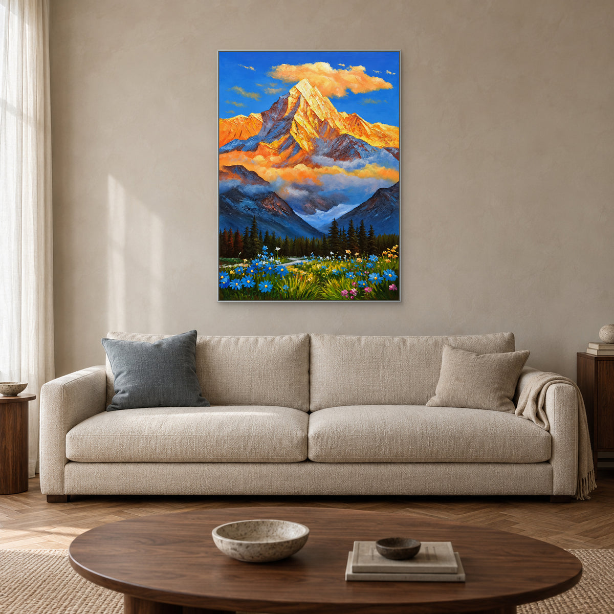 Golden mountain painting in a silver-tone floating frame above a cream sofa with a blue-grey cushion