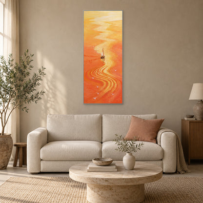 Orange sea and golden reflection in a silver-tone frame above a cream sofa with a muted coral cushion