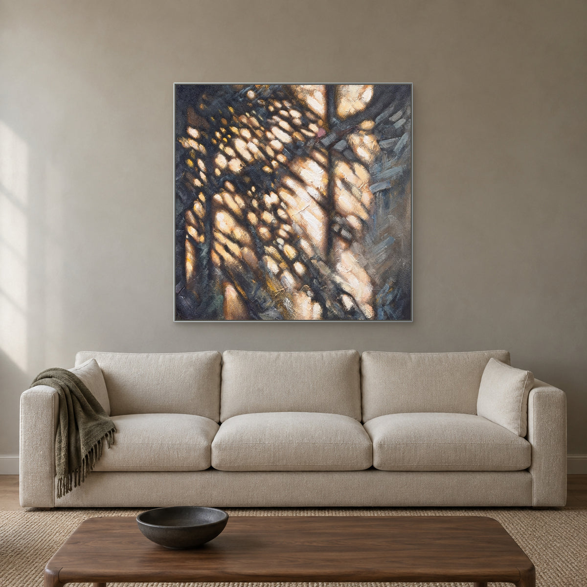 Dappled Gold square abstract in a silver floating frame centred above a cream sofa