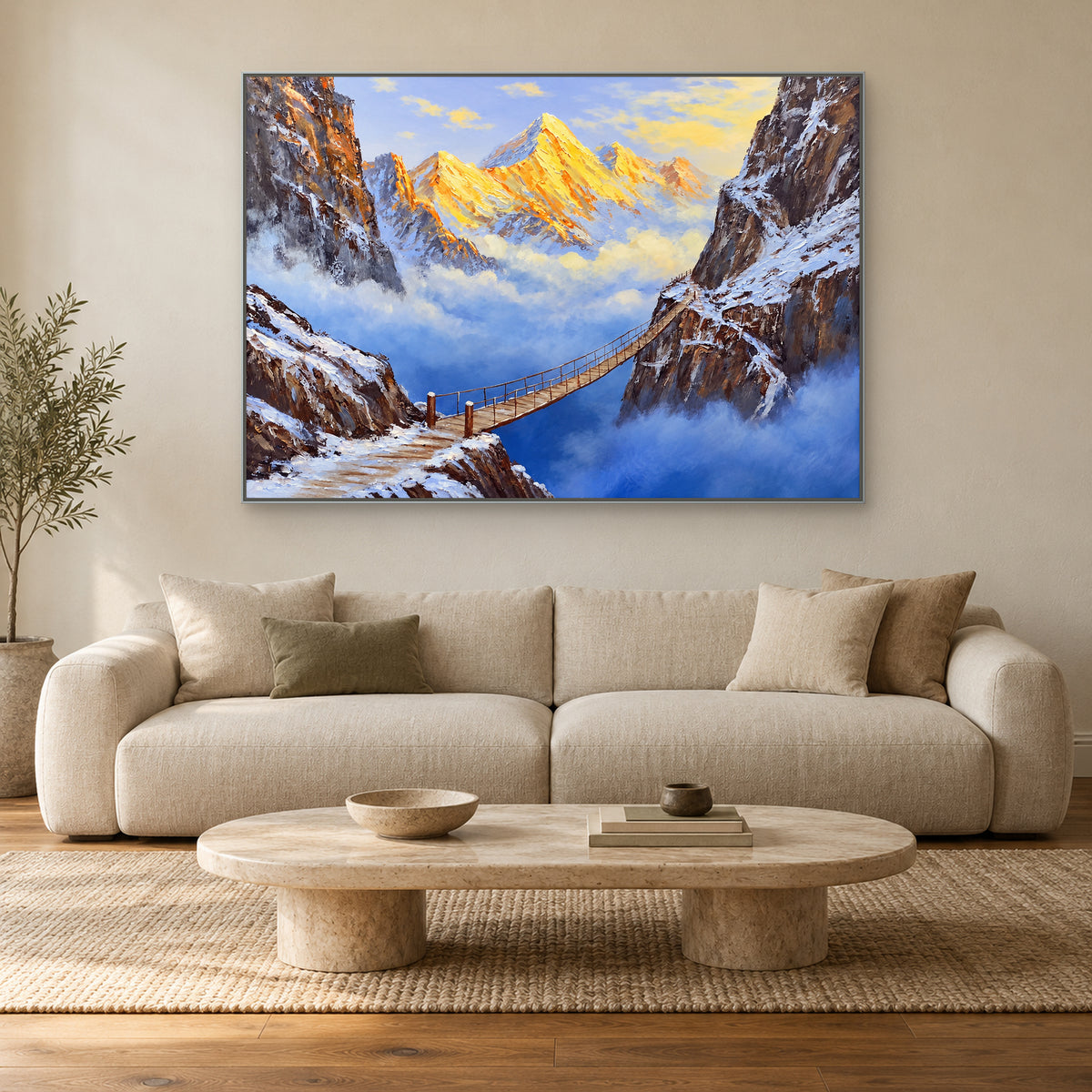 Horizontal snowy canyon painting in a slim silver-tone frame above a neutral sofa