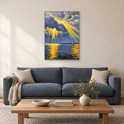 Textured sea and golden sky painting in a thin silver-tone frame centred above a blue-grey sofa.