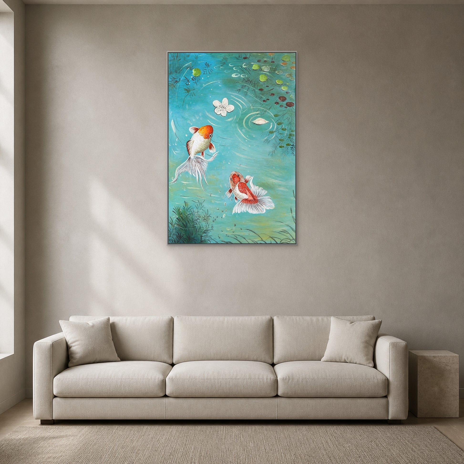 Vertical aqua koi artwork in a thin silver floating frame centred above a light neutral sofa