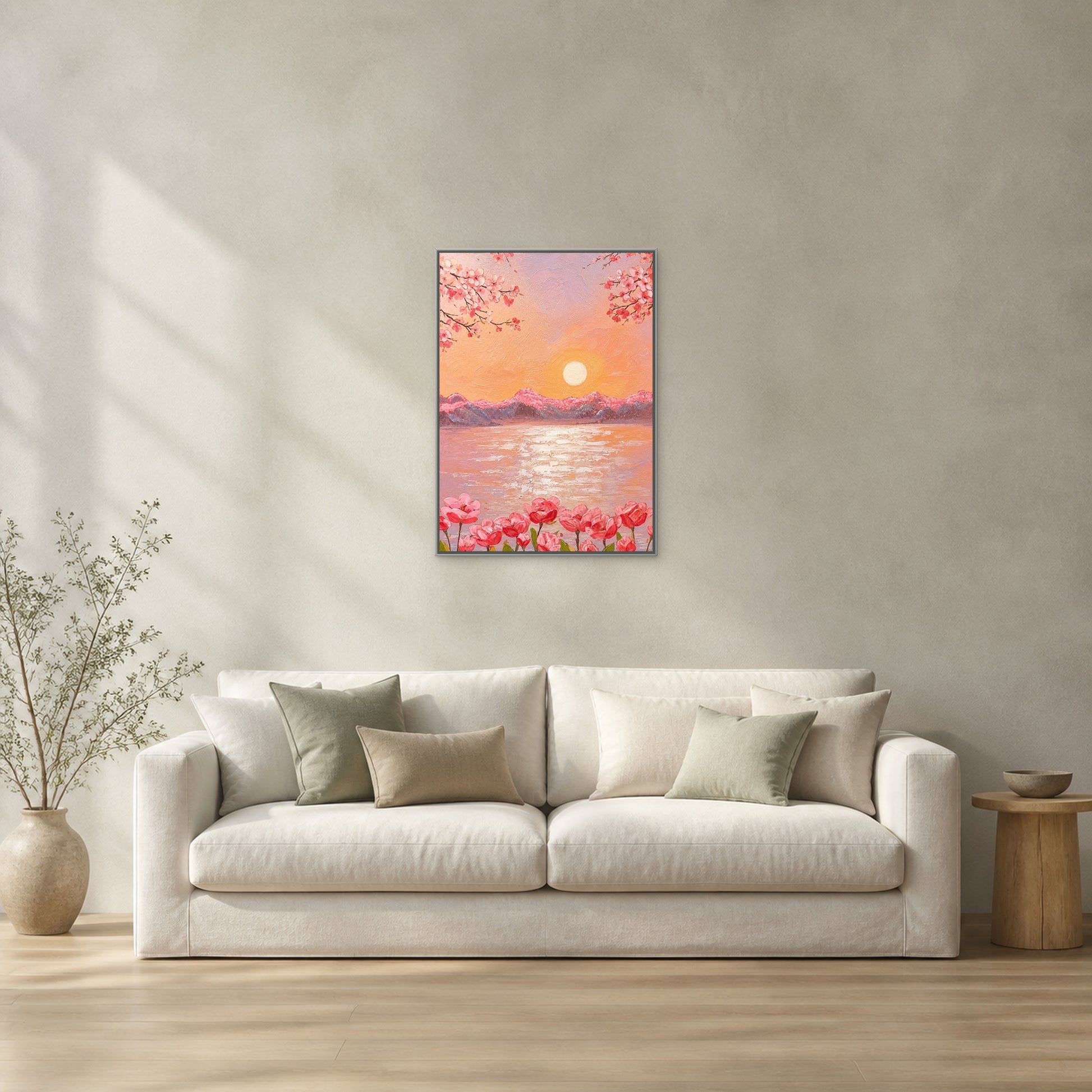 Cherry Blossom Sunset Lake in a slim silver floating frame centred above a cream sofa on a pale sage-grey wall
