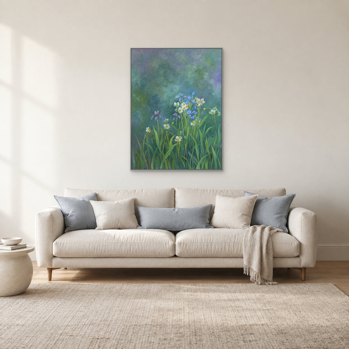 Teal floral artwork in a silver-tone frame above a cream sofa with pale blue cushions