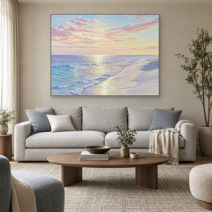 Blue surf and pink sky artwork in a silver-tone frame centred above a light grey living-room sofa