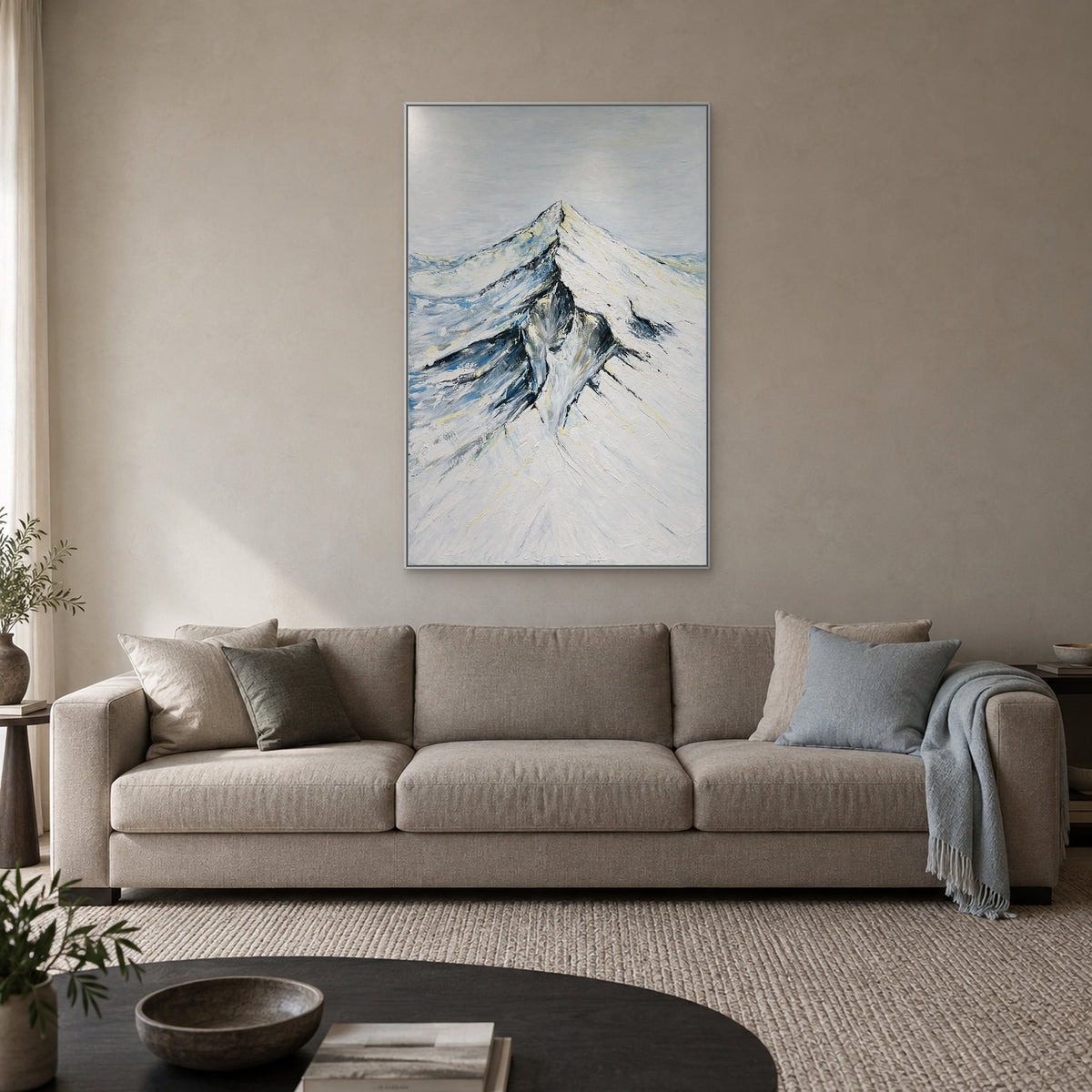 Snowcrest mountain wall art in a silver-tone frame above a neutral sofa