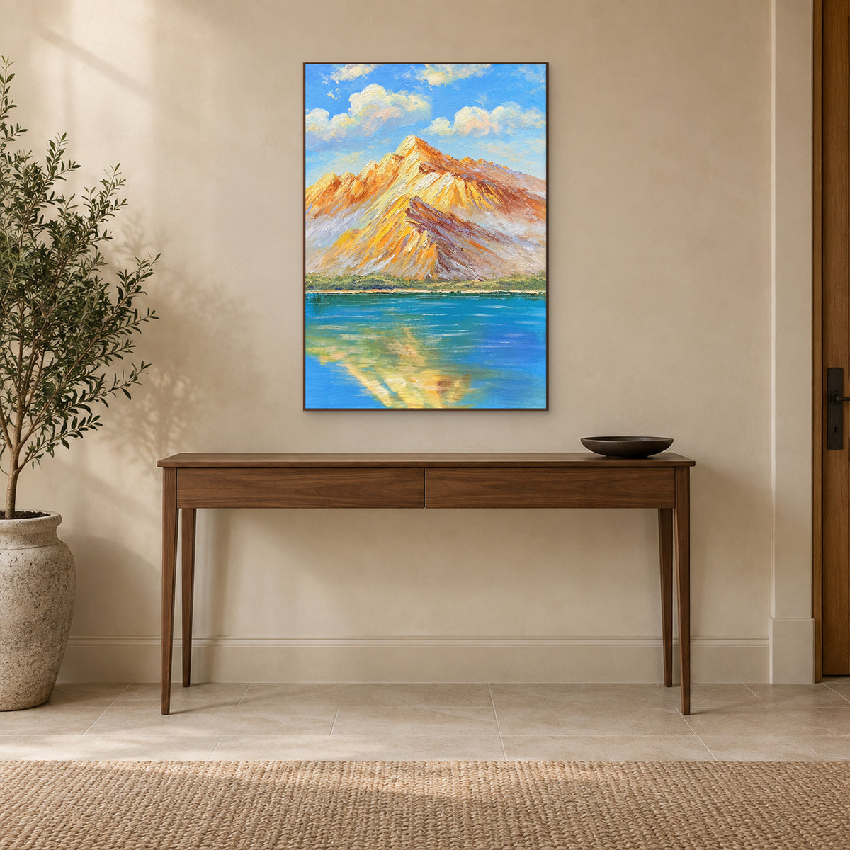 Tableau de lac et de montagne dans un cadre ton noyer, au-dessus d'une fine console d'entrée en bois