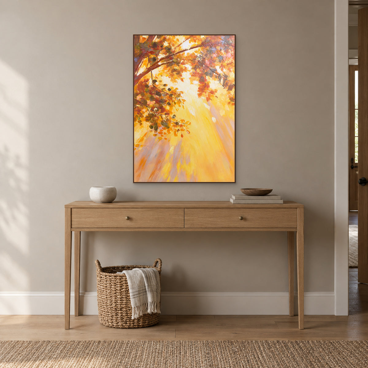 Vertical amber tree painting in a dark wood-look frame centred over a light wood entryway console.