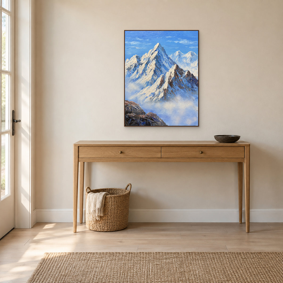 Blue mountain painting with a dark wood-tone frame above an oak entryway console