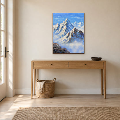 Blue mountain painting with a dark wood-tone frame above an oak entryway console