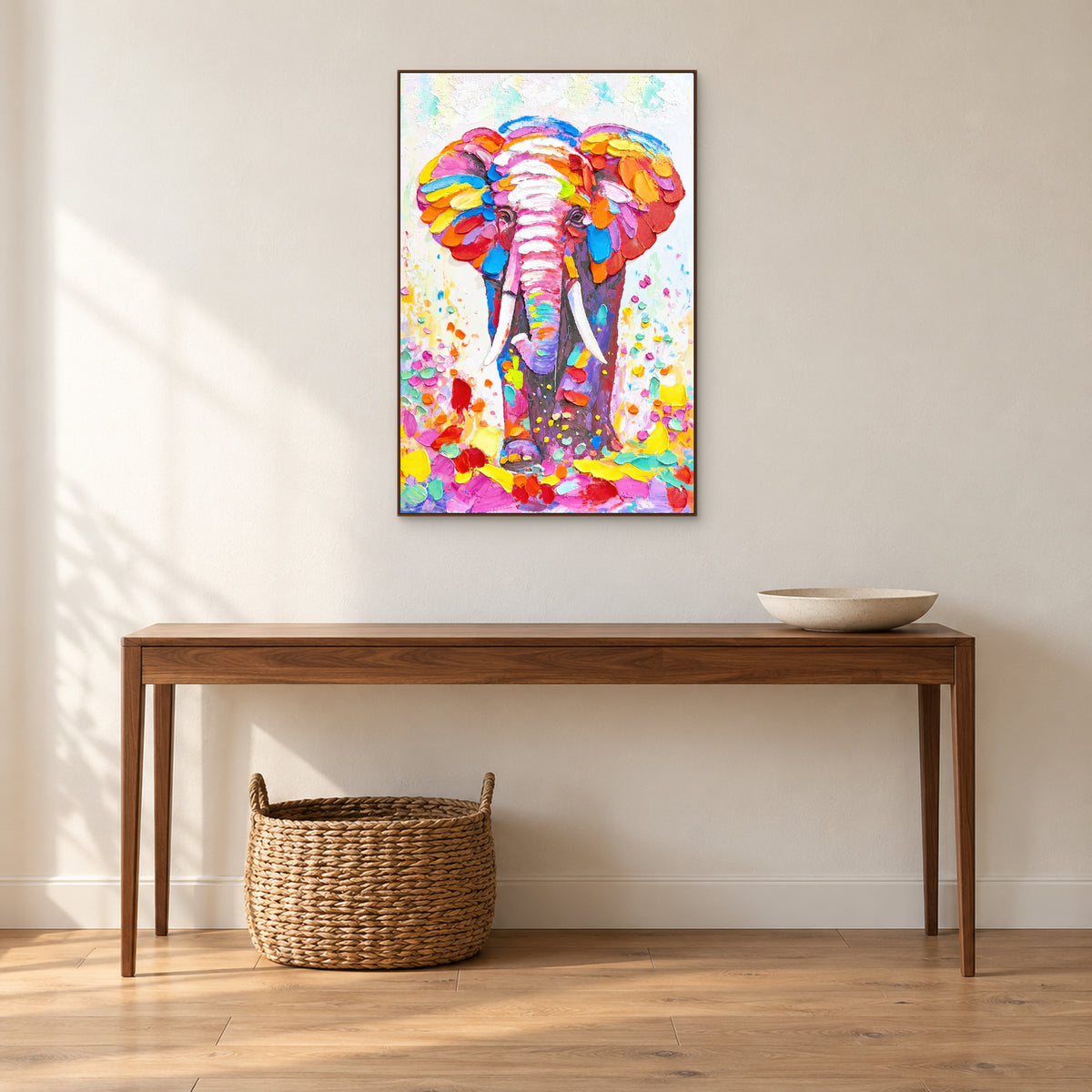 Portrait d’éléphant dans un cadre ton noyer au-dessus d’une console, avec une coupe et un panier tressé dessous