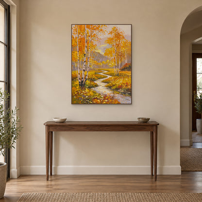 Golden birch stream artwork in a walnut-toned frame above a wooden entryway console